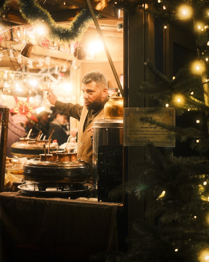 service-02 A vendor at Berlin Christmas market serving traditional food under festive lights.